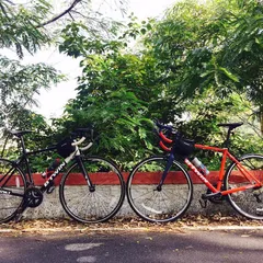 Two Btwin Triban road bikes, the perfect machines for a challenging climb like Nandi Hills, resting side-by-side.