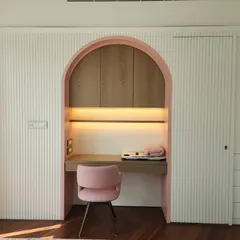 A sneak peek of a tranquil study nook we're creating at our Indiabulls Blu project. The soft pink arch and fluted wall panels create a calm and focused workspace with a touch of elegance.