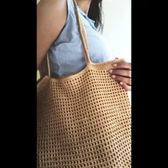 A closer look at the detailed waffle stitch on our crochet jhola bag. This technique creates a sturdy yet flexible fabric that is perfect for a durable tote.