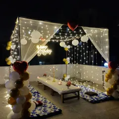 This angle highlights the enchanting canopy of fairy lights and paper lanterns above the cabana dinner setup. We pay attention to every detail to ensure a cozy and romantic atmosphere for your special occasion.