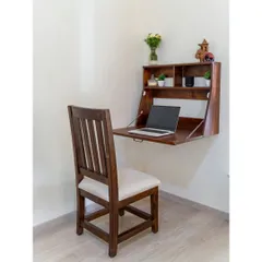 This wall-mounted folding desk is a seamless addition to the guest bedroom. When closed, it's a discreet cabinet; when open, it provides a sturdy and functional workspace, complete with shelves for essentials.