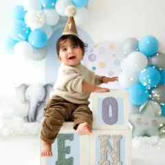 Another adorable shot from a first birthday session, with colorful "ONE" blocks. These milestone photoshoots are a wonderful way to mark the occasion.
