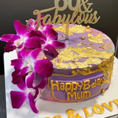"60 & Fabulous" indeed! A gorgeous purple and gold cake for a mom's special birthday, decorated with fresh orchids and edible gold leaf.