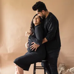 A sweet and tender embrace from behind. This pose is perfect for showing the support and love that surrounds you during your pregnancy.