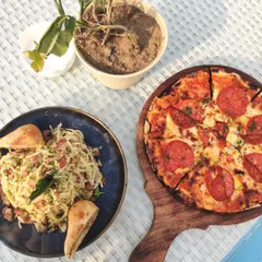 A classic pairing of pepperoni pizza and spaghetti carbonara, served al fresco. Our menu features a range of European and Indian classics to satisfy any craving.