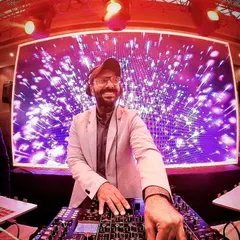 The mix master in action. A great shot of me focused on the music, with a fantastic LED backdrop lighting up the party.