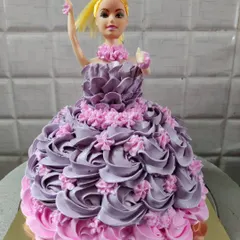 My classic doll cake, a favorite for children's birthdays. This design features a beautiful gown made of intricately piped purple and pink buttercream rosettes.