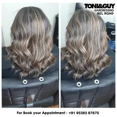 This client wanted a significant change with highlights. We created this high-contrast look with blonde highlights on a dark base, styled into waves to blend the colors and add texture.