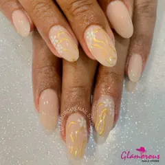 A soft and elegant design featuring a nude base with delicate, hand-painted white flowers and wavy gold lines for a touch of warmth.