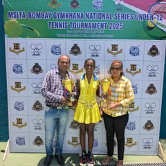 Trisha Bhosale with her family and her two winner's trophies from the U-12 National Series. Family support is crucial, and we work closely with parents to help our players succeed.
