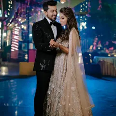 A classic portrait from an engagement party in Lucknow. The couple looks stunning in their coordinated outfits, and the soft lighting creates a romantic and celebratory mood.