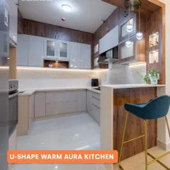 A perfect blend of warmth and modernity in this U-shaped kitchen. We combined wood-finish cabinets with light grey tones and added a breakfast bar, creating a cozy and inviting space that is also highly functional.