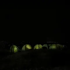 Our campsite glowing under the night sky. This is what our overnight camping trips look like, a peaceful escape with a view of the city lights far below.