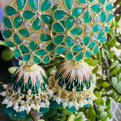 My Meenakari jhumkas are a mood lifter, and this green pair is a perfect example. The detailed floral stonework and hand-painted enamel dome bring a pop of color and traditional artistry to your look.