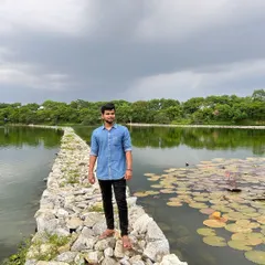 Pausing to enjoy the view of the calm water and the greenery on the opposite bank.
