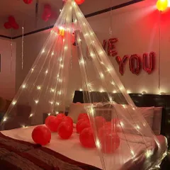 My canopy designs can be combined with other elements like balloons and romantic messages. Here, the lit canopy perfectly frames the bed and complements the "I Love You" theme.