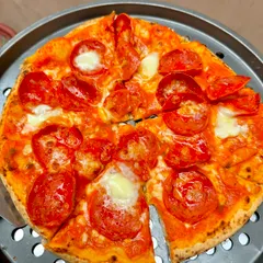 A close-up of our classic pepperoni pizza, fresh out of the oven. The glistening pepperoni and melted mozzarella on a perfectly cooked crust show the delicious quality we serve at every event.