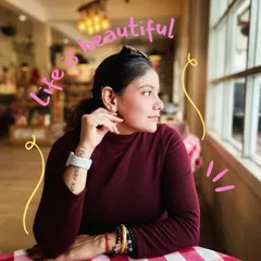 A candid shot of me looking out a cafe window, capturing a moment of quiet reflection. The doodle 'Life is beautiful' adds a touch of my personal, dreamy aesthetic.