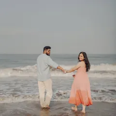 A candid moment from Anushka and Manu's beach pre-wedding session. This relaxed, "follow me" style captures the joy and movement of their connection against the ocean waves.
