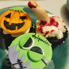 Spooky and delicious! These Halloween-themed cupcakes, featuring a jack-o'-lantern, Frankenstein's monster, and a bloody finger, are always a huge hit.