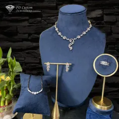 A complete and dazzling bridal or festive set. It includes a diamond necklace, matching earrings, a modern mangalsutra, and a statement diamond ring, all designed to complement each other perfectly.