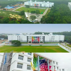 A panoramic view of the Amrita International Vidyalayam campus, showing the main building, expansive sports ground, and surrounding greenery.