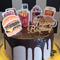 I can create cakes based on any fun theme, even your favorite food spots. This chocolate drip cake was customized with McDonald's and Starbucks toppers for a unique and modern birthday celebration.