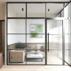 This view from outside the private office highlights the use of fluted glass partitions to maintain privacy while allowing natural light to flow through the space.