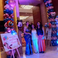 The welcome area for a 7th birthday party. We set up a custom welcome sign on an easel and a colorful balloon arch with Mickey Mouse foil balloons to greet the guests.