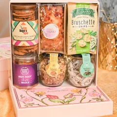 This gourmet snack hamper is a treat for the foodie sibling. It's packed with chocolate chip cookies, bruschetta chips, beet root mathi, and assorted flavored nuts, all in a beautifully designed floral box.