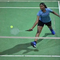 An adult player lunging forward for a net shot, demonstrating excellent reach and technique. Our training is for all ages and skill levels.