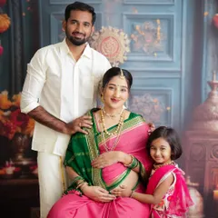 A beautiful family portrait celebrating tradition. The family is dressed in gorgeous ethnic wear, with big sister proudly standing by her mother's side.