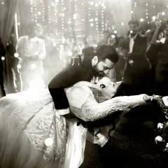 "Dance like there was no tomorrow." This black and white shot of the first dance captures the romance and movement beautifully, with fairy lights creating a magical atmosphere.