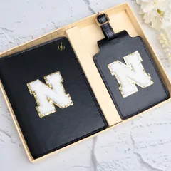 Our classic black passport cover and luggage tag set, personalized with a fuzzy and glittery chenille patch initial. This is one of our most popular travel combos, perfect for adding a touch of personal style to your journeys.