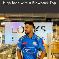 This High Fade with a Blowback Top is a popular and versatile men's hairstyle. The high fade keeps the sides neat, while the voluminous top adds a touch of modern flair, perfect for any occasion.