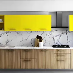 We brought a burst of sunshine into this kitchen with bright yellow overhead cabinets. The vibrant color is balanced by natural wood-finish base cabinets and a white marble-patterned backsplash, creating a cheerful and contemporary look.