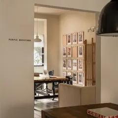 A peek into our main workspace from the entrance, with the "Purple Backyard" name marking the threshold. This view shows the open and layered nature of our studio design, encouraging a sense of flow and transparency within the team.