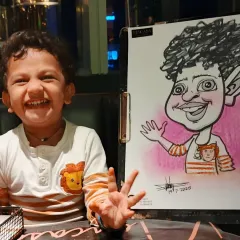 The pure joy on a child's face says it all. This caricature from a birthday party captures his happy spirit, making for a perfect, personalized return gift that kids and parents absolutely love.