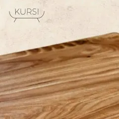 The smooth, polished surface of a live-edge teak tabletop. It's where the raw beauty of the wood meets refined craftsmanship, creating a surface that is both beautiful and functional.