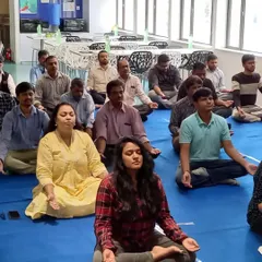 Employees at Samsung participating in a guided meditation session. Learning to simply sit and be present is a powerful tool for managing workplace stress and improving mental clarity.