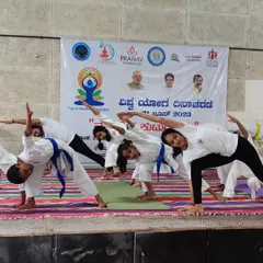 Our students practicing Trikonasana (Triangle Pose) during a yoga session. We integrate yoga and stretching to improve flexibility, balance, and mental focus, which are essential skills for any martial artist.