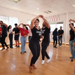 Here I am guiding students through a simple partner turn. We rotate partners in class so you get to dance with everyone and nobody feels left out, which is the best way to learn social dancing.