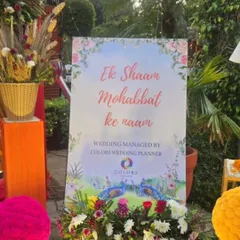 A romantic welcome sign with the phrase 'Ek Shaam Mohabbat ke naam' (An Evening in the Name of Love). Surrounded by floral arrangements, this sign adds a poetic and personal touch to the celebration.