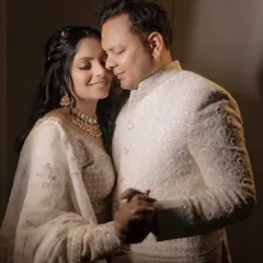 An engagement portrait captured with soft, warm light. The focus is on the couple's gentle dance and happy expressions, highlighting the joy and intimacy of their relationship.