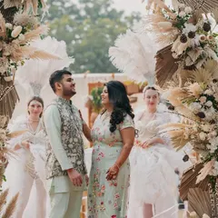 A sweet, interactive moment between the couple under a beautiful floral arch. These natural, unposed moments often make for the best photographs.