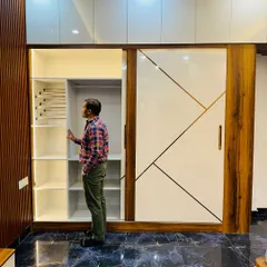 A closer look at the custom shelving, including a pull-out trouser rack. These small details in wardrobe planning make daily use much more convenient.