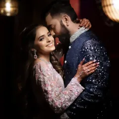 An intimate embrace in a warmly lit room. The soft lighting and their close connection create a cozy and romantic mood, perfect for capturing the tender side of a couple's love story.