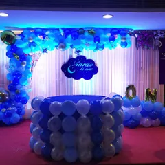 A popular choice for a boy's first birthday is this moon and stars theme. I provide a complete package including the custom name sign, a balloon-covered cake table, and a full backdrop to make the celebration special.