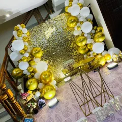An angled shot from above, showing the layout of the gold and white balloon decor.