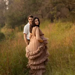 I love it when a couple has a special place, and we made sure to capture it. The way she looks back, her beautiful gown catching the light, creates such a romantic and dreamy outdoor pregnancy portrait.